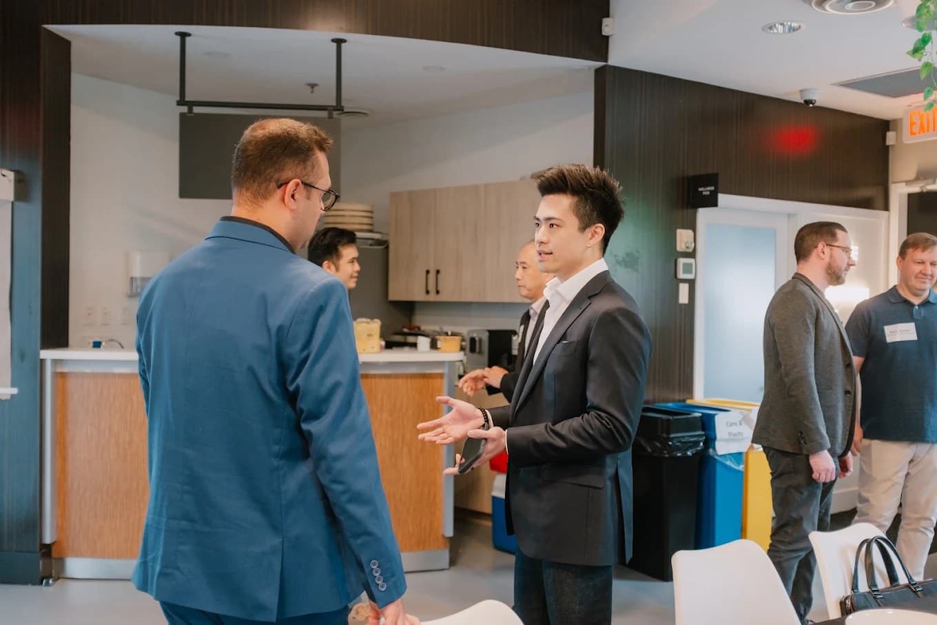 Chris Ng talking with clients and colleagues